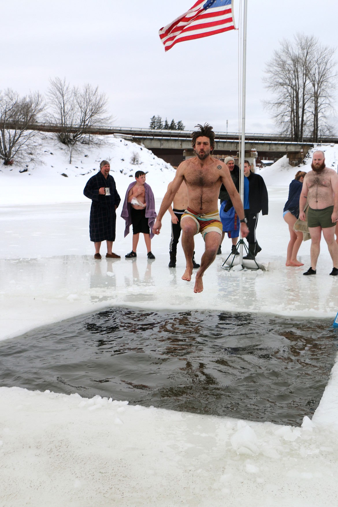 (Photo by CAROLINE LOBSINGER)
A Polar Bear Plunge participant jumps into Lake Pend Oreille as he took part in Boy Scout Troop 111's annual event.