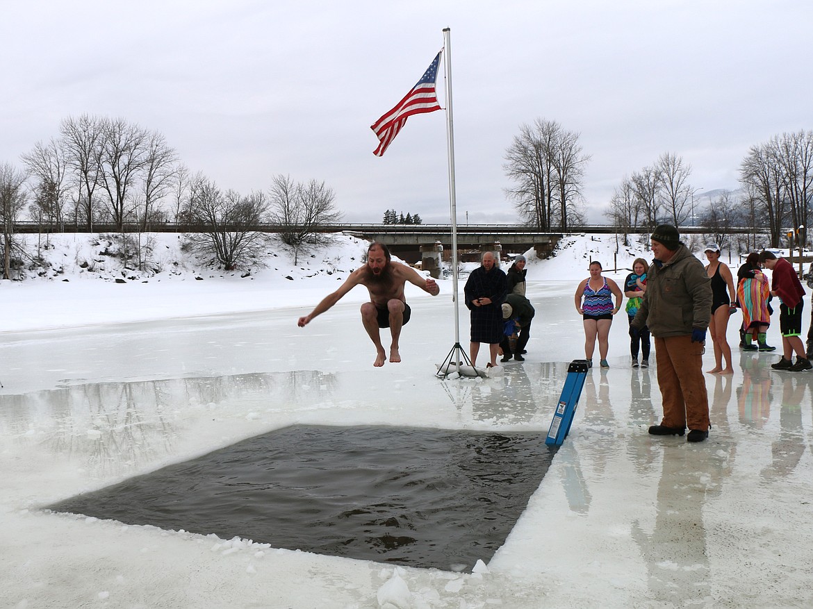 (Photo by CAROLINE LOBSINGER)
A Polar Bear Plunge participant leaps into Lake Pend Oreille during Boy Scout Troop 111's annual event Monday on New Year's Day.