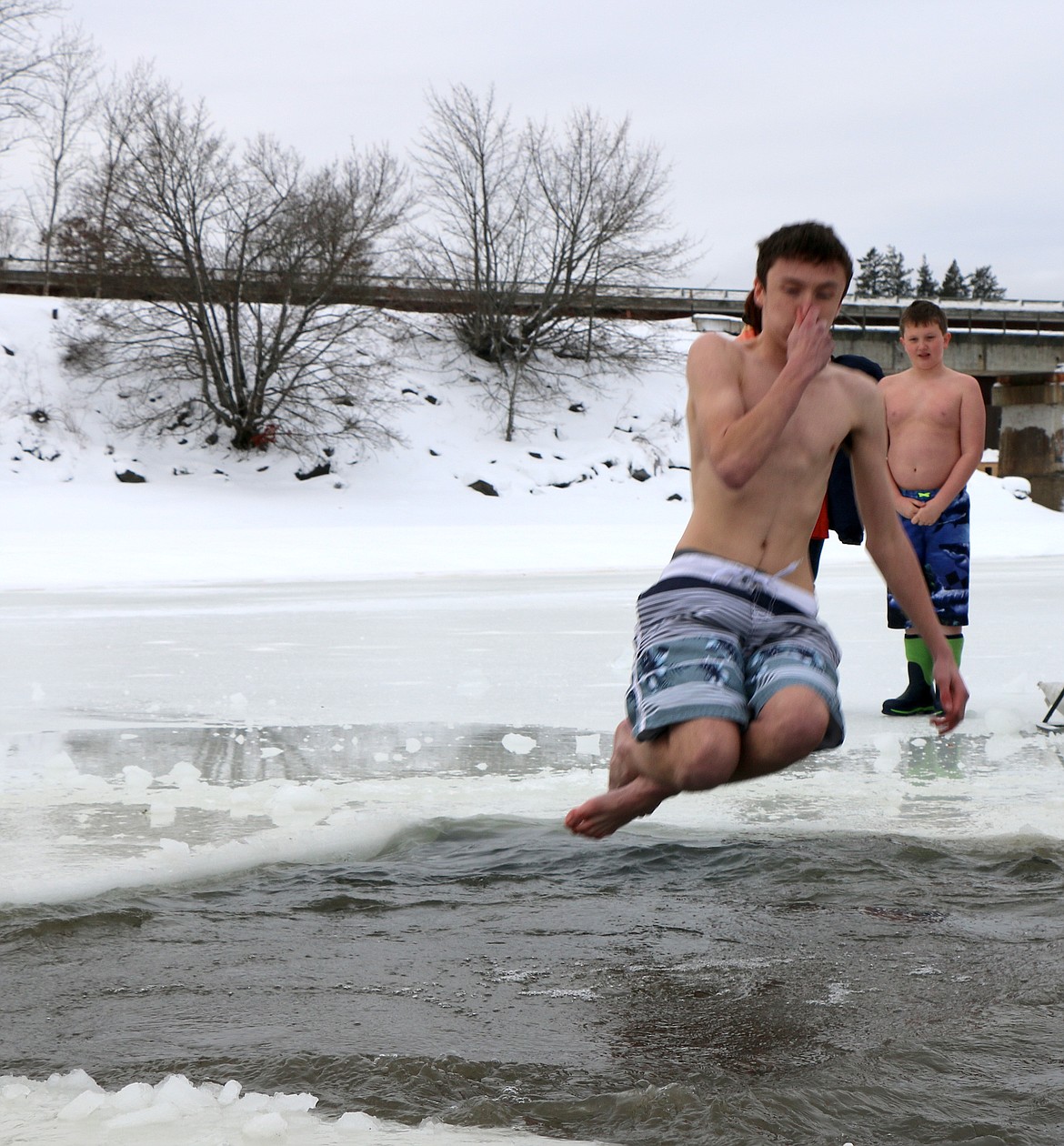 (Photo by CAROLINE LOBSINGER)
A Polar Bear Plunge participant jumps into Lake Pend Oreille during Boy Scout Troop 111's annual event Monday on New Year's Day.