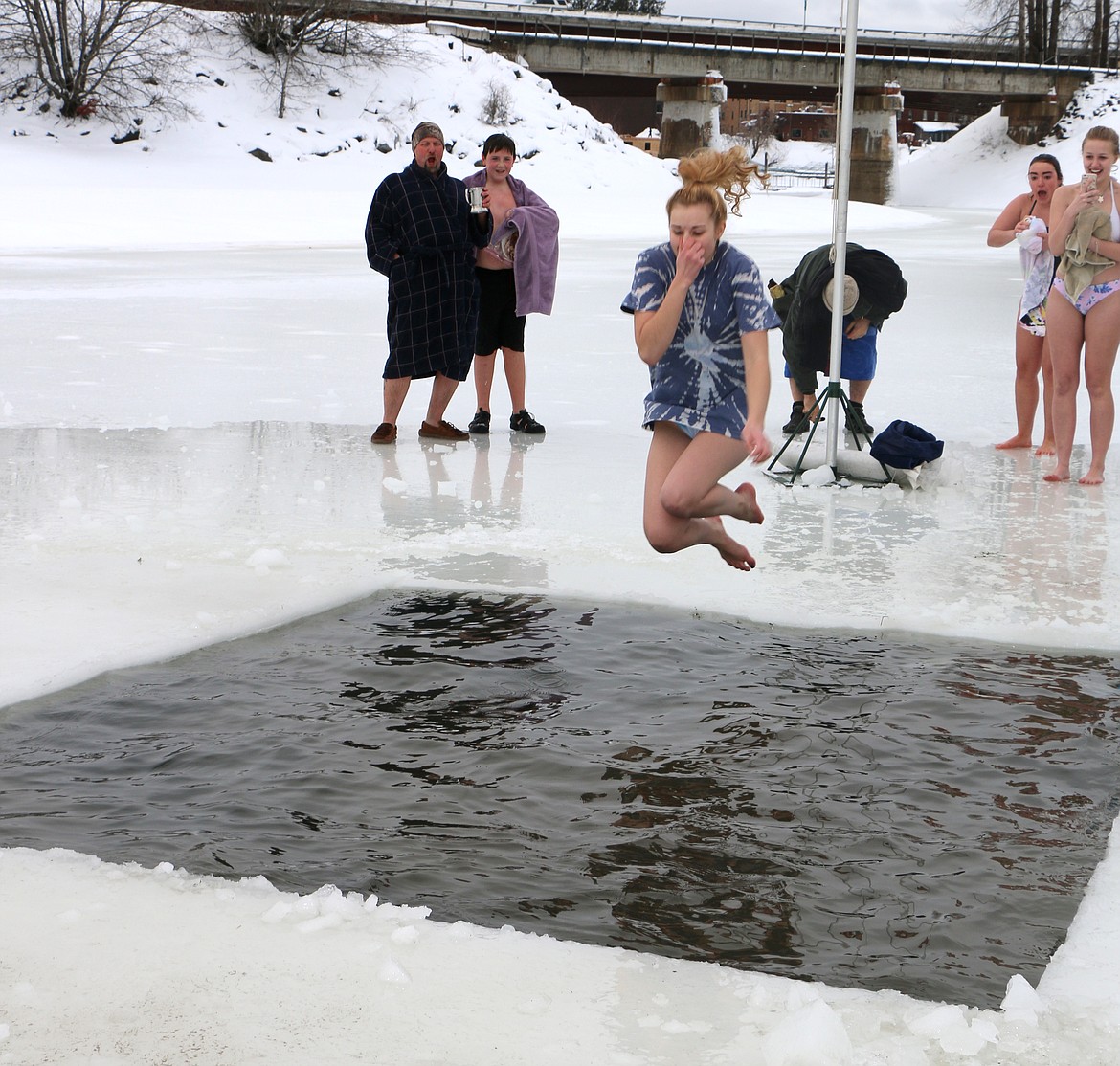 (Photo by CAROLINE LOBSINGER)
A Polar Bear Plunge participant plugs her nose as she jumps into Lake Pend Oreille during Boy Scout Troop 111's annual event Monday on New Year's Day.