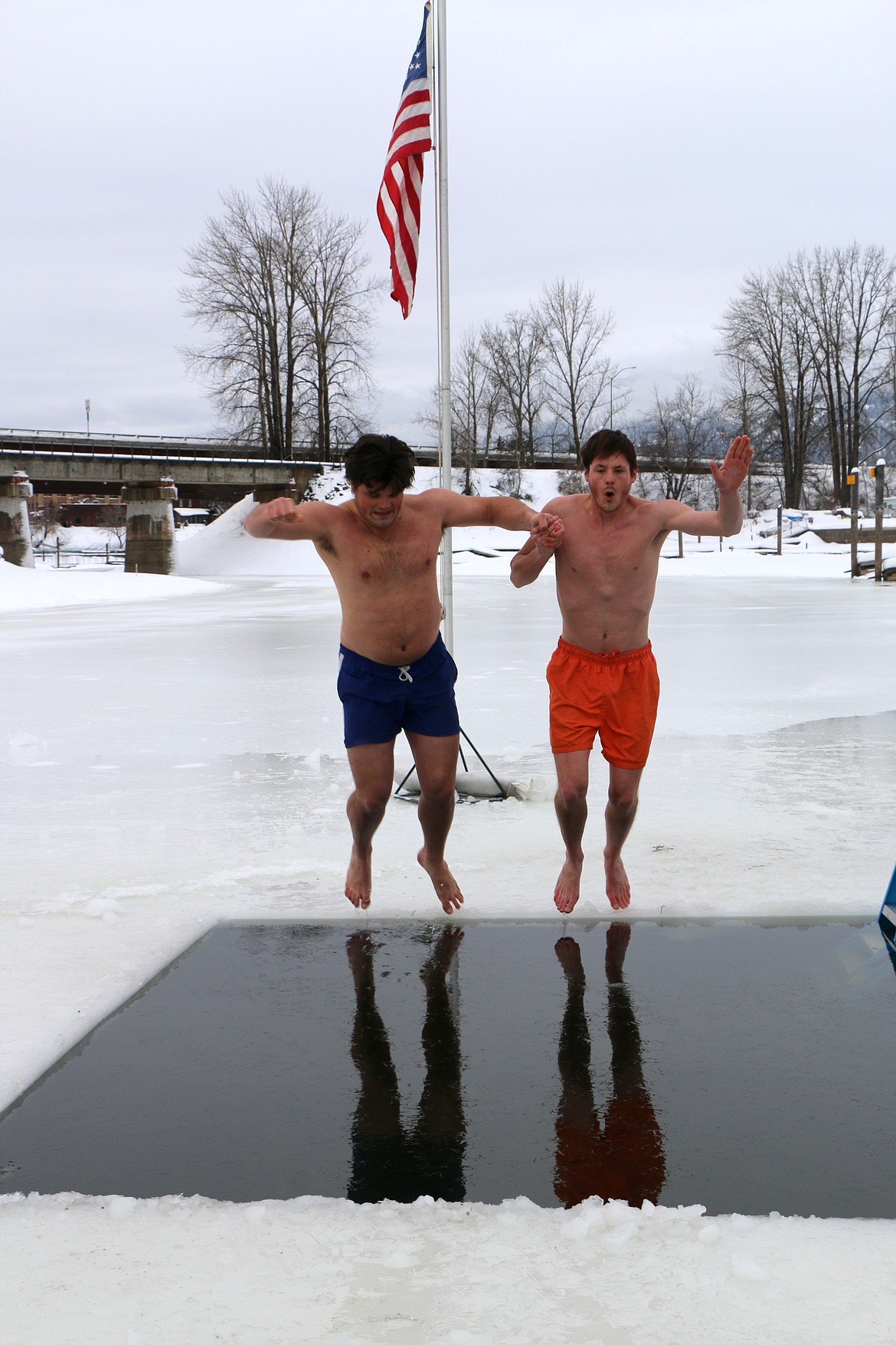 (Photo by CAROLINE LOBSINGER)
Two brothers jump into Lake Pend Oreille during Boy Scout Troop 111's annual event Monday on New Year's Day.