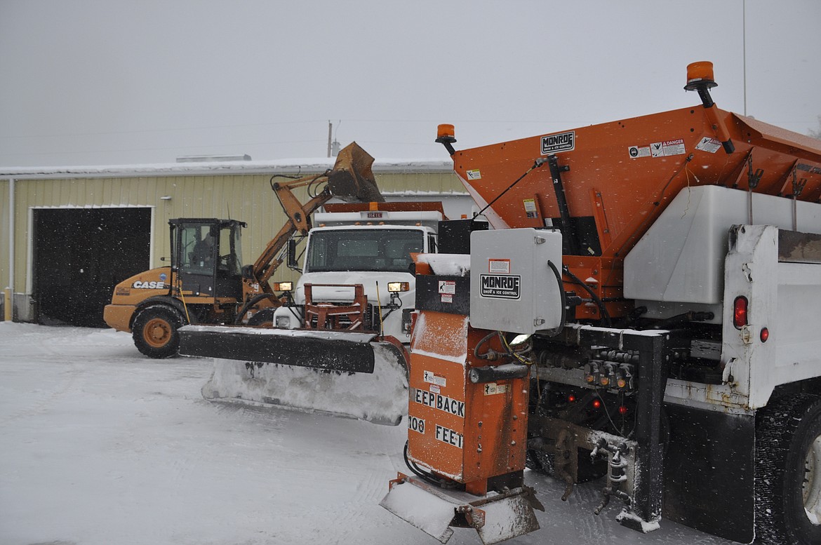 Polson Street crews stock their plow trucks with sand and gravel as the snow storm begins to pick up its pace late Friday morning. (Ashley Fox/Lake County Leader)