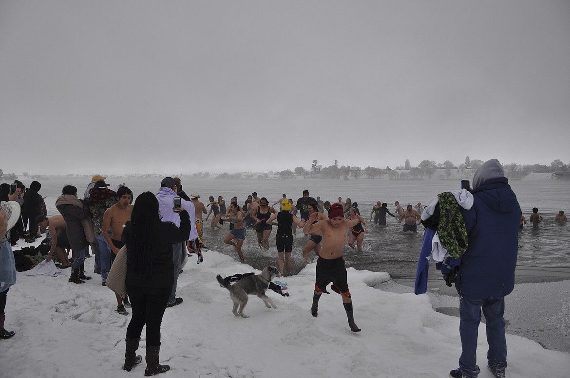 About 60 people braved chilling temperatures New Years Day in Polson for the unofficial Polar Plunge at Riverside Park. (Ashley Fox/Lake County Leader)