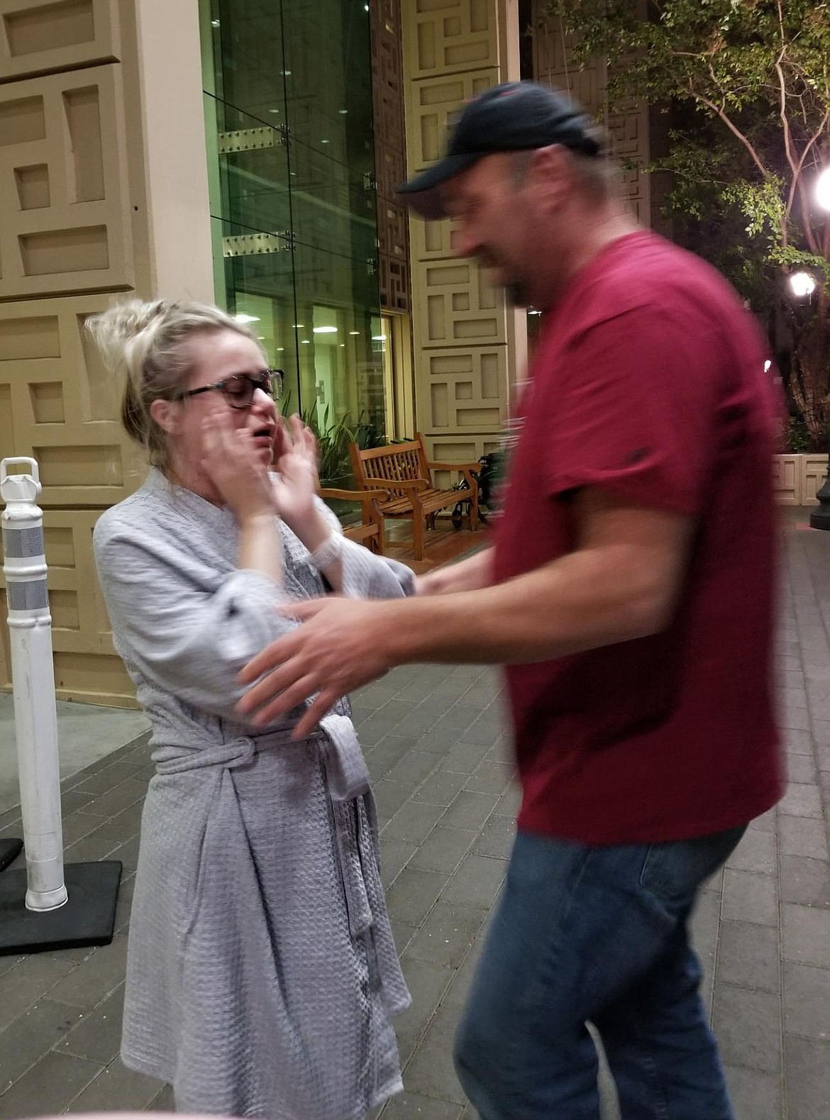 It's an emotional moment for Alex Heisel, 26, of Post Falls, left, and dad, Jim, as Alex breathes her first outside air in November upon discharge from the Stanford University Medical Center following her lung transplant surgery. Alex is now home and will be taking it easy for a few months, although she is ahead of her predicted recovery time. (Courtesy photo)