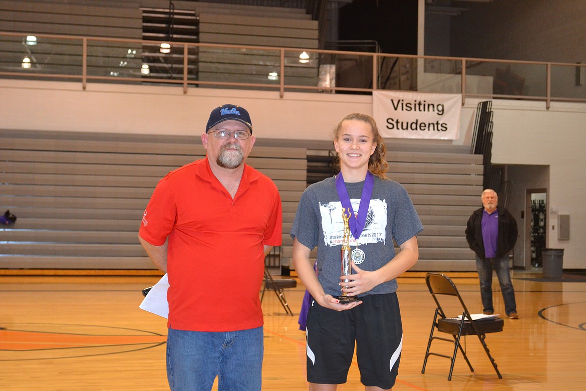 Photo by PAT BRADEN
Coeur d&#146;Alene Hoop Shoot Director Rick Alexander presents River City Middle School&#146;s Alexis Heath with her fourth Waide Hamner Top Gun award, breaking the record she shared with two-time National Hoop Shoot finalist Zach Mackimmie. Not pictured is boys Hamner winner Jace Taylor of Betty Kiefer Elementary School.