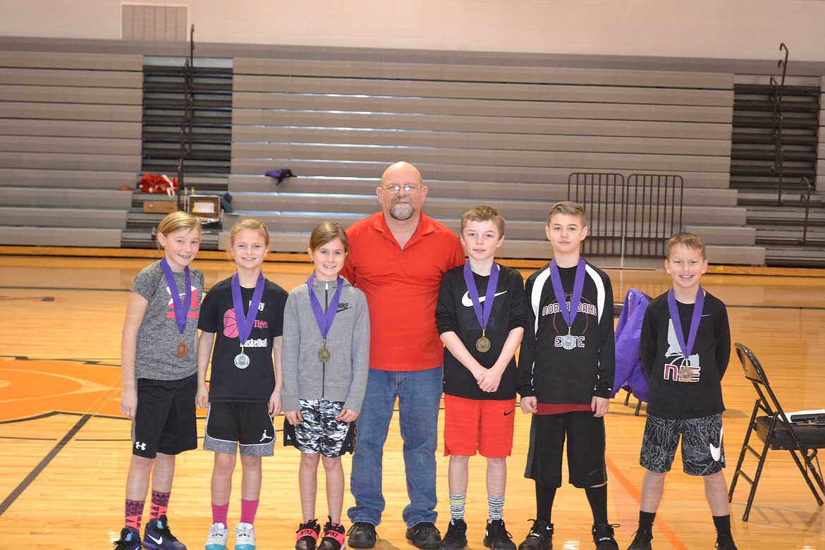 Photo by PAT BRADEN
Pictured from left are the Coeur d&#146;Alene Elks Hoop Shoot medalists in the girls 8-9 age &#151; group bronze medalist Addyson Chase, silver medalist Malia Miller and champion Kaylee Paulson, Hoop Shoot Director Rick Alexander Jr., boys champion Jace Taylor, runner-up Britton Johnston and bronze medalist Ben McElvany.