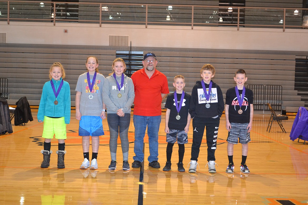 Photo by PAT BRADEN
Pictured from left are the Coeur d&#146;Alene Elks Hoop Shoot medalists in the girls 10-11 age group &#151; third-place finisher Kyler Kirking, silver medalist Kamryn Pickford and gold medalist Payton Sterling, Hoop Shoot Director Rick Alexander Jr., boys 10-11 champion Paxton Winey, silver medalist Stockton Montague and bronze medalist Steven Anderson.