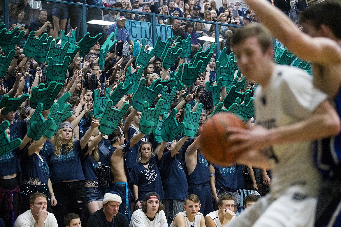 Students in the Lake City High School student section raise their foam rock fingers during Fight for the Fish 2018 last Friday at Lake City High.