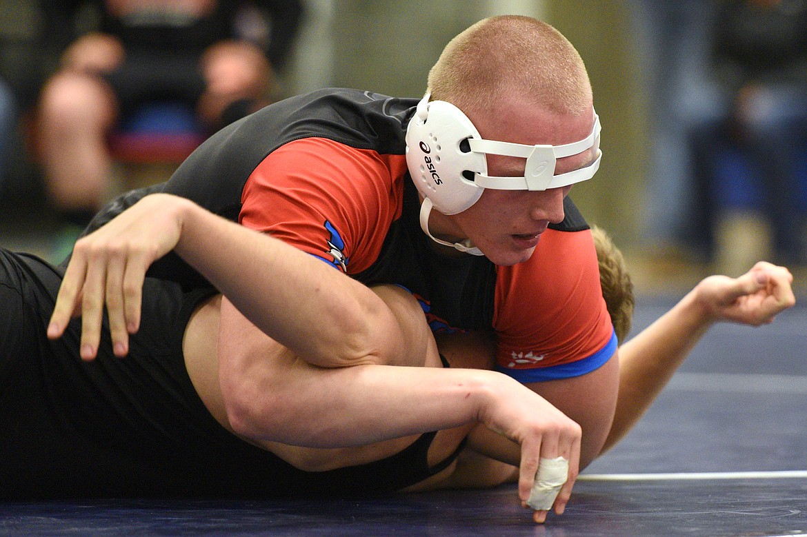 Bigfork's Logan Kaminsky works toward a pin of Eureka's Simon Gromberg at 205 pounds at Bigfork High School on Tuesday. (Casey Kreider/Daily Inter Lake)