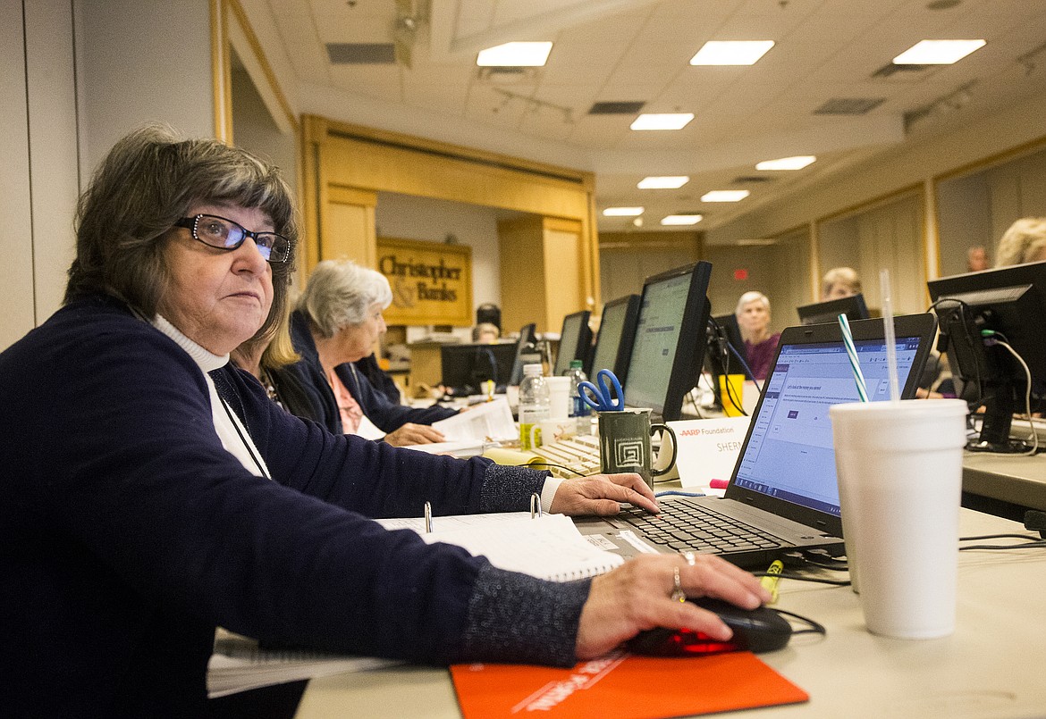 Volunteer Dona Conley follows instructions and tax scenarios during an AARP Tax Aid class Wednesday afternoon at Silver Lake Mall. (LOREN BENOIT/Press)