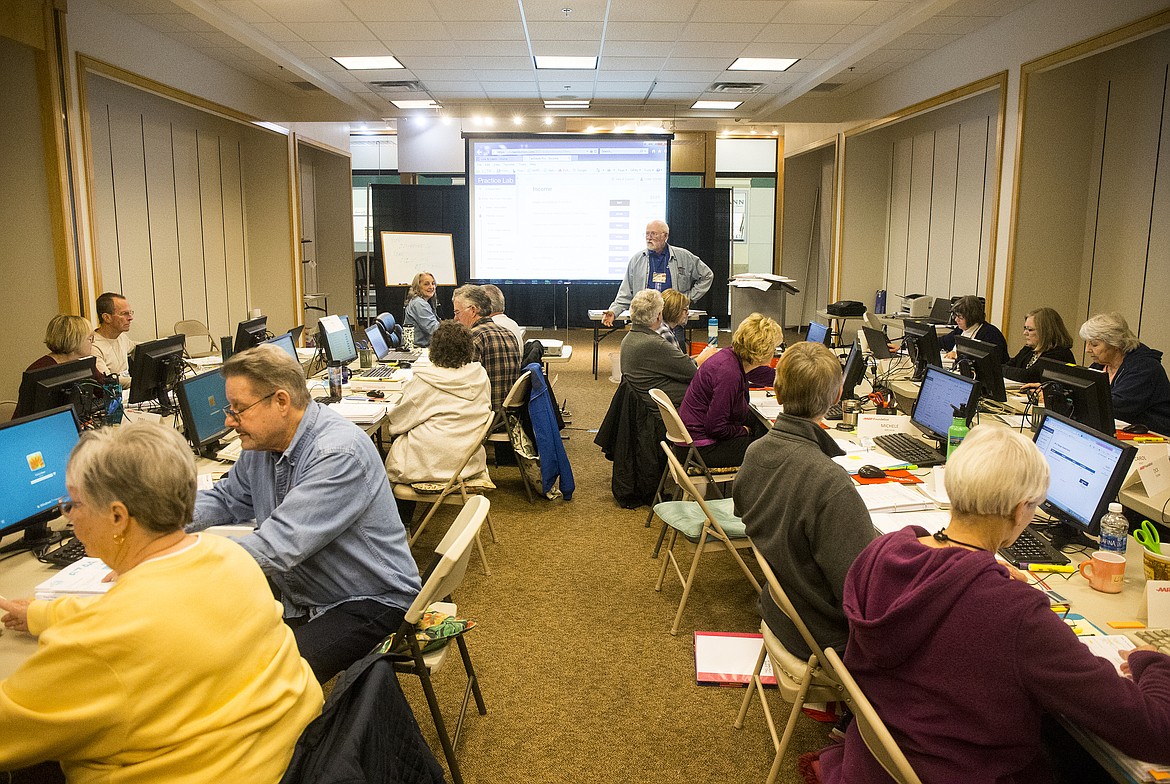 Warren Fisher gives instructions to around 20 volunteers during an AARP Tax Aid class Wednesday afternoon at Silver Lake Mall. (LOREN BENOIT/Press)