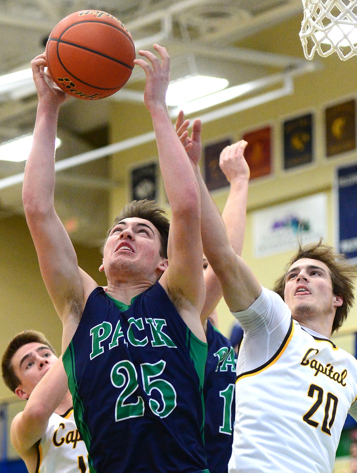 Glacier&#146;s Nick Whitman grabs a rebounder over Helena Capital&#146;s Chase Spotorno during a 44-38 win at Glacier High School on Saturday. (Casey Kreider/Daily Inter Lake)