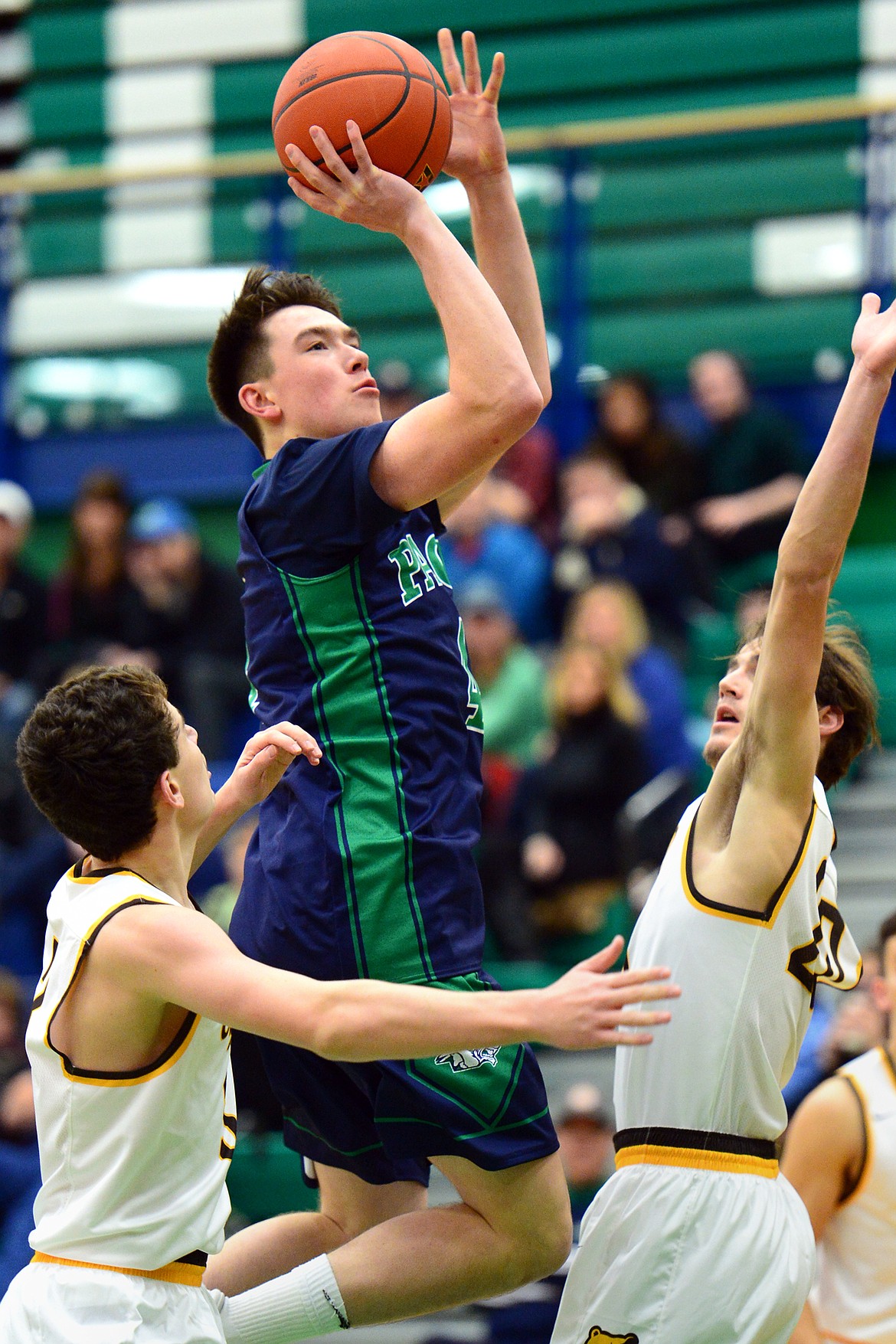 Glacier&#146;s Collin Kazmier drives the lane and shoots between Helena Capital defenders Parker Johnston, left, and Chase Spotorno during a 44-38 win at Glacier High School on Saturday. (Casey Kreider/Daily Inter Lake)