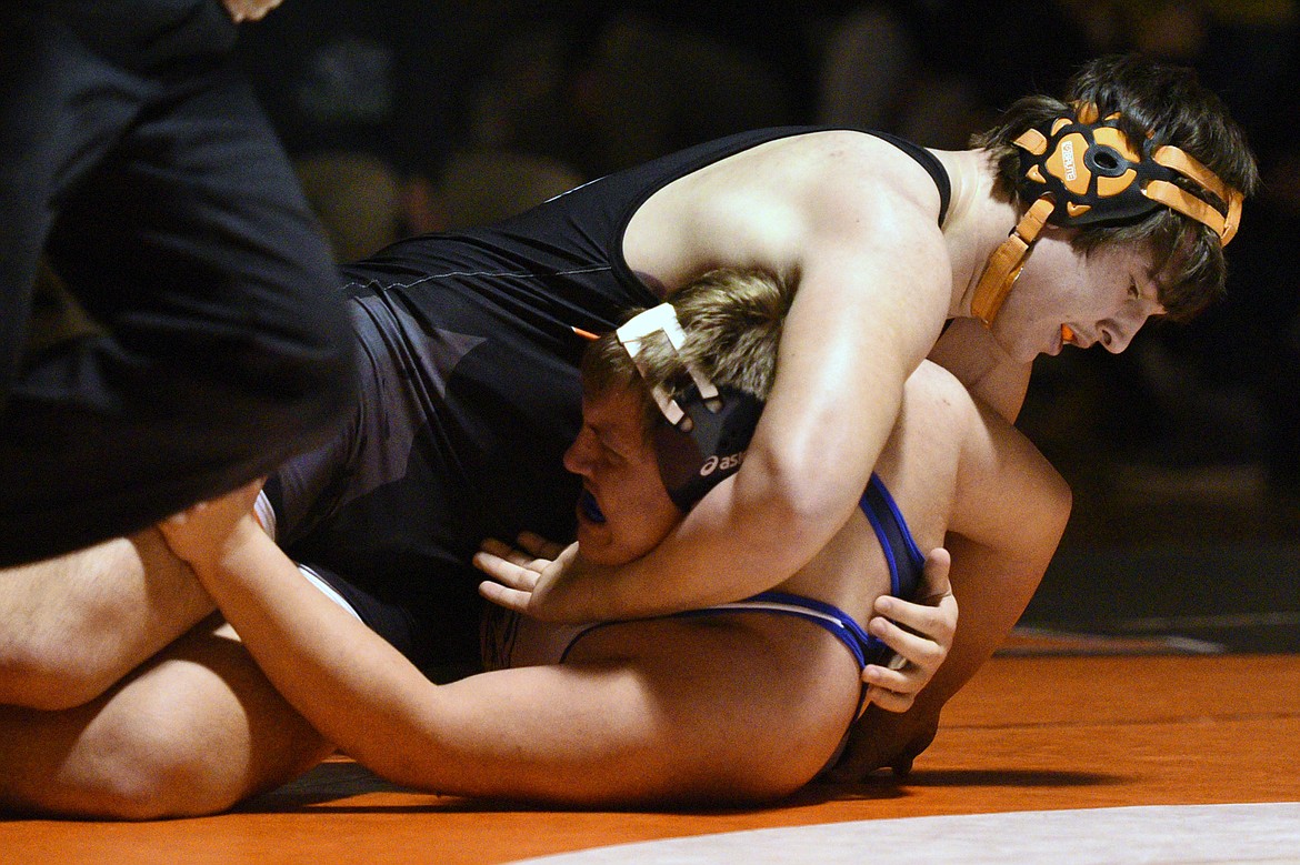 Flathead's Michael Lee works toward a pin of Glacier's Ashton Thompson in the heavyweight match on Thursday at Flathead High School. (Casey Kreider/Daily Inter Lake)