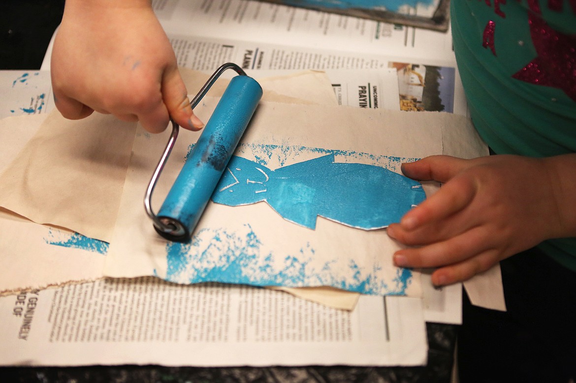 Scout Nelson applies ink to her foam stencil in preparation of making a print during a Wednesday morning art class.