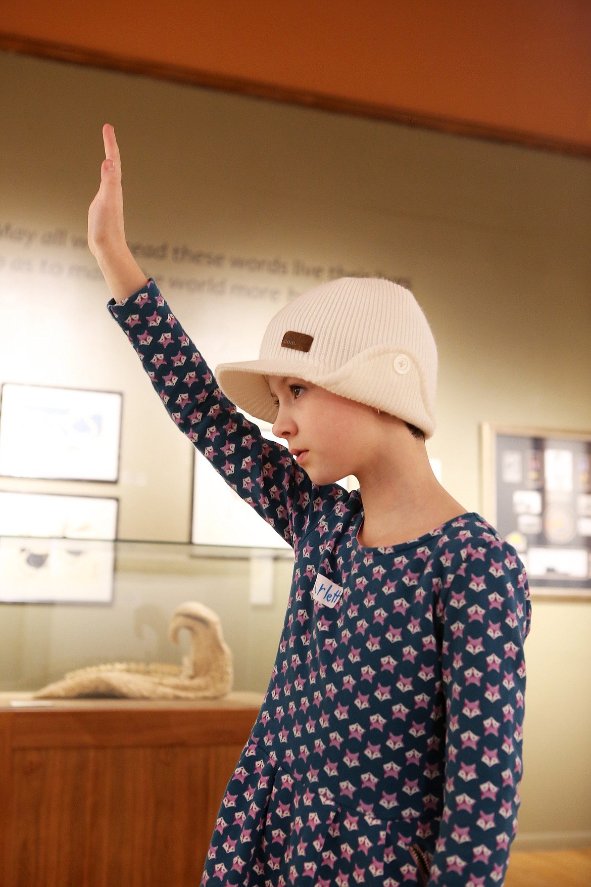 Scarlett St. Marie, 8, raises her hand during a tour of the collection of Sam and Jean Bibler at the Hoackaday Museum of Art. (Mackenzie Reiss/Daily Inter Lake)