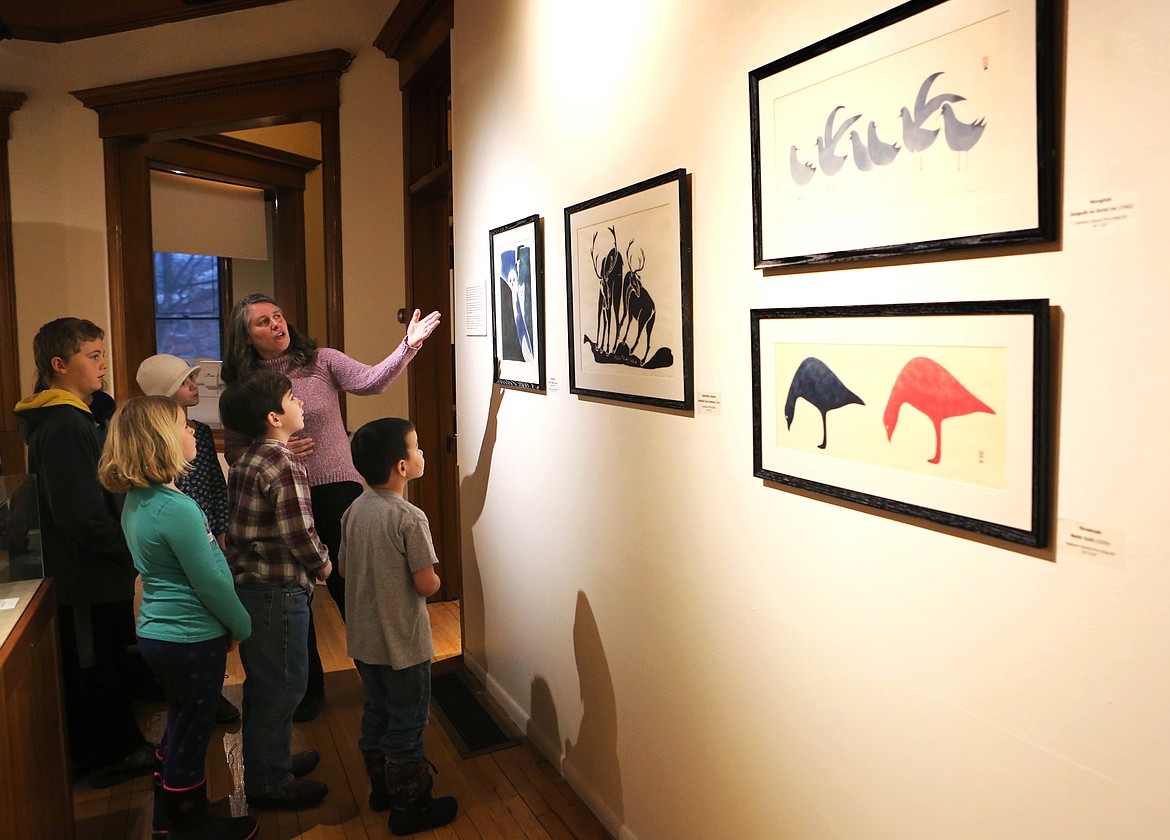 Hockaday Museum of Art Director of Education Kathy Martin shows a series of Inuit prints to a class of home-school students.