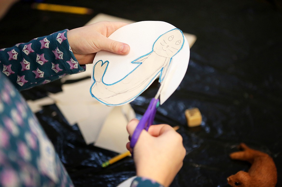 Scarlett St. Maries, 8, cuts out her drawing of a seal during art class at the Hockaday Museum of Art. (Mackenzie Reiss/Daily Inter Lake)