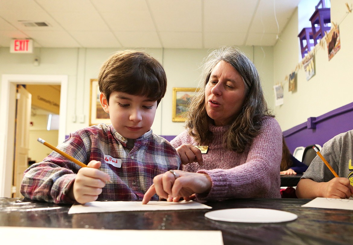 Rolland Burgess, 8, gets a few pointers from Hockaday Museum of Art Director of Education Kathy Martin. (Mackenzie Reiss/Daily Inter Lake)