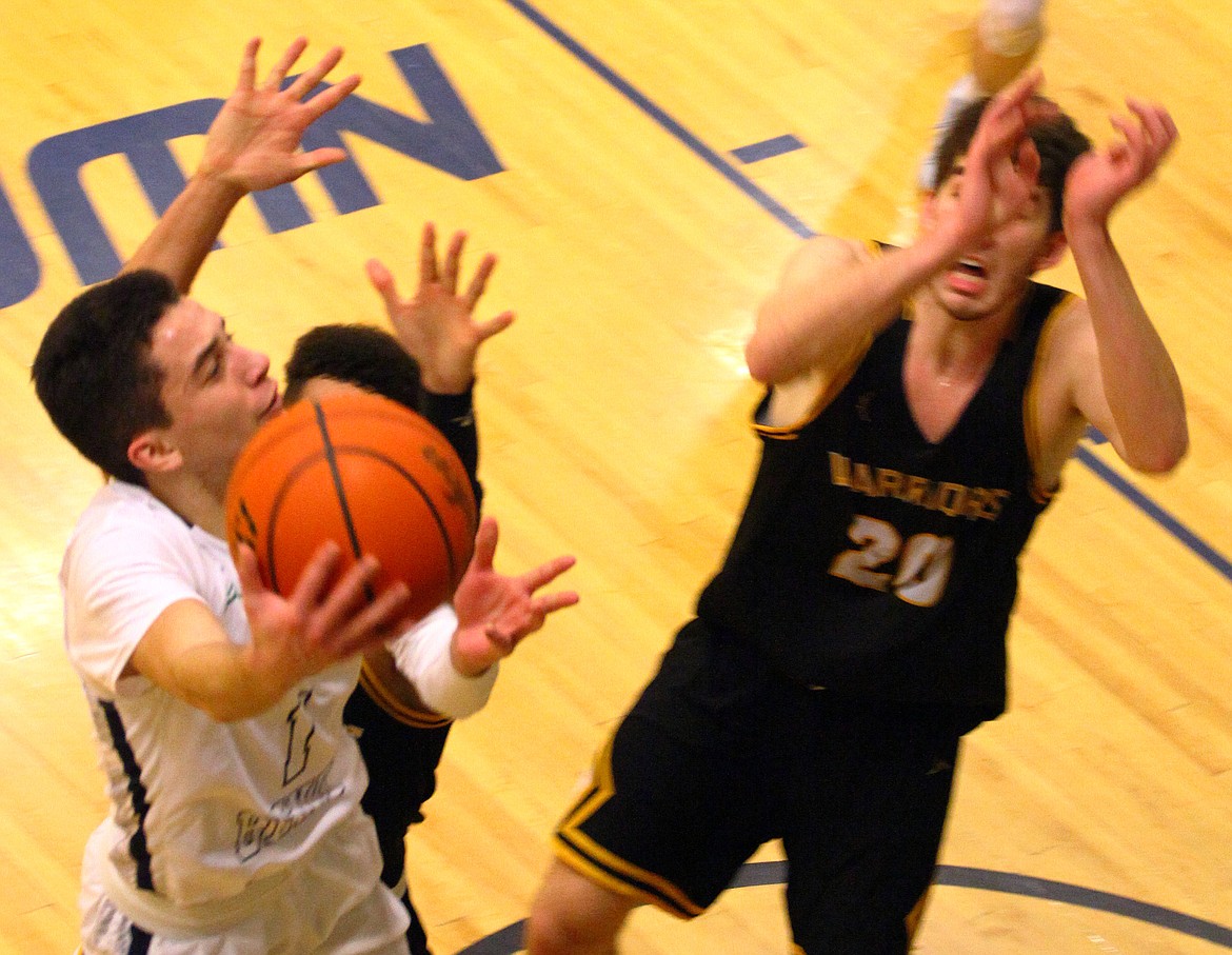 Rodney Harwood/Columbia Basin HeraldBig Bend point guard Koby Huerta (1) drives to the basketball against Jake Albright (20) of Walla Walla during the first half of Saturday's NWAC East game at DeVries Activity Center.