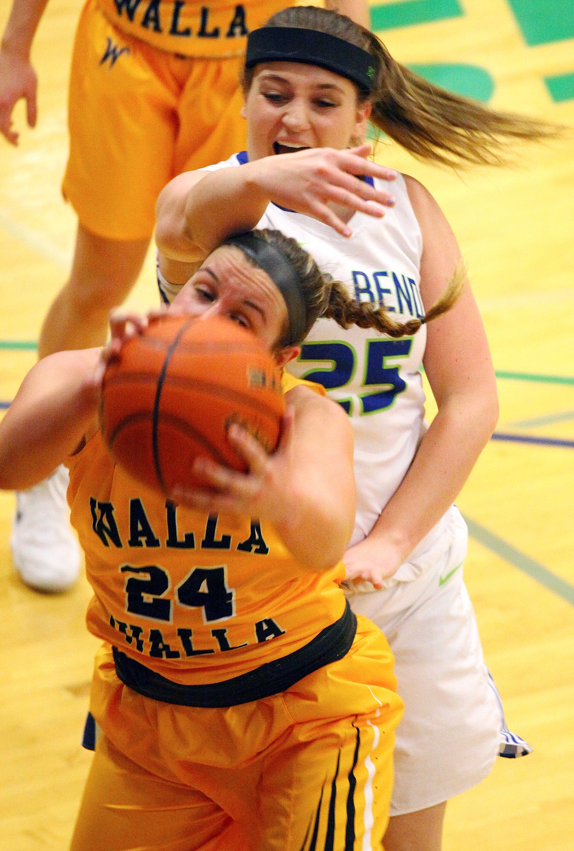 Rodney Harwood/Columbia Basin HeraldBig Bend post Kelsey Foster (25) reaches for a rebound against Walla Walla's Taylor Turner (24) during the second quarter of Saturday's NWAC East game at DeVries Activity Center.