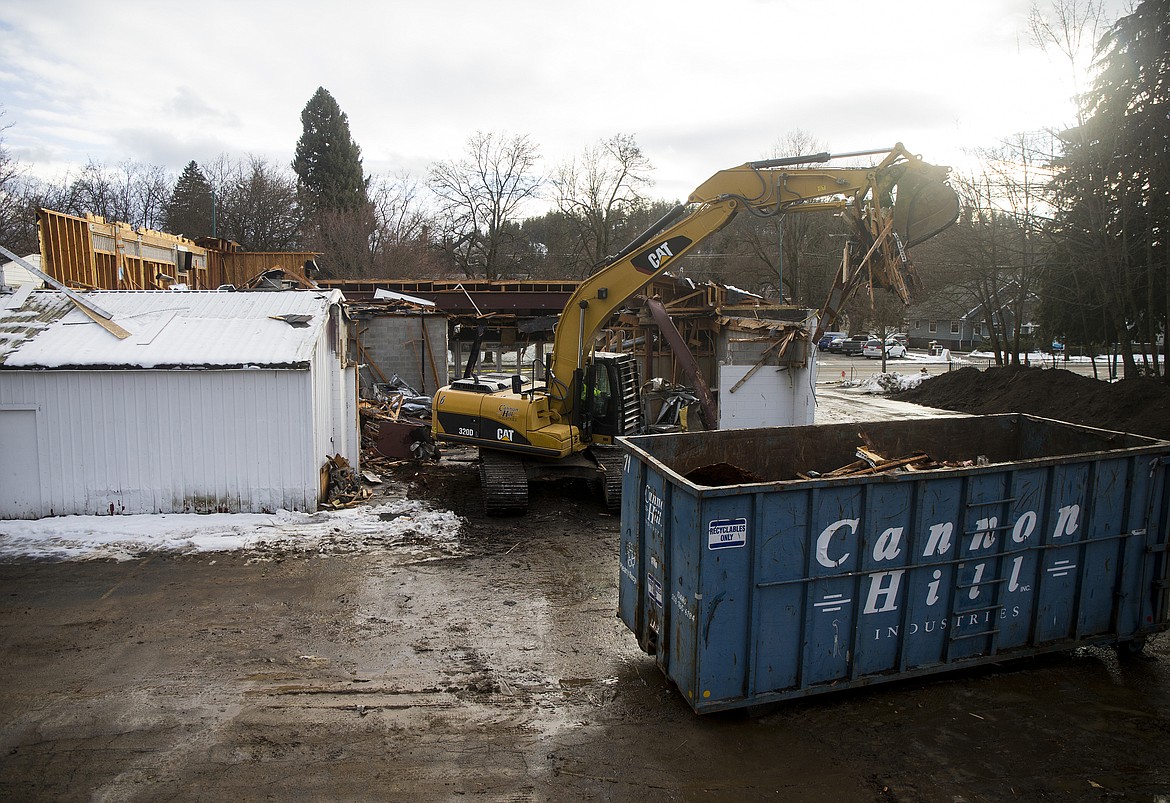 A worker watches an excavator remove ceiling boards from the old Java on Sherman building on Wednesday in Coeur d'Alene. (LOREN BENOIT/Press)