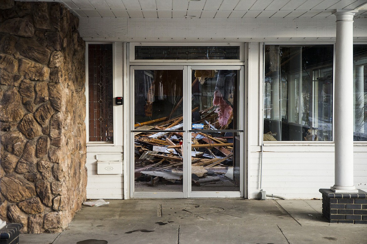 Ceiling boards are seen on the ground Wednesday afternoon at the old Java on Sherman building. The building is being torn down.  Before the building was constructed, the site was the home to lumber tycoon Frederick Blackwell in the early 1900s.  (LOREN BENOIT/Press)