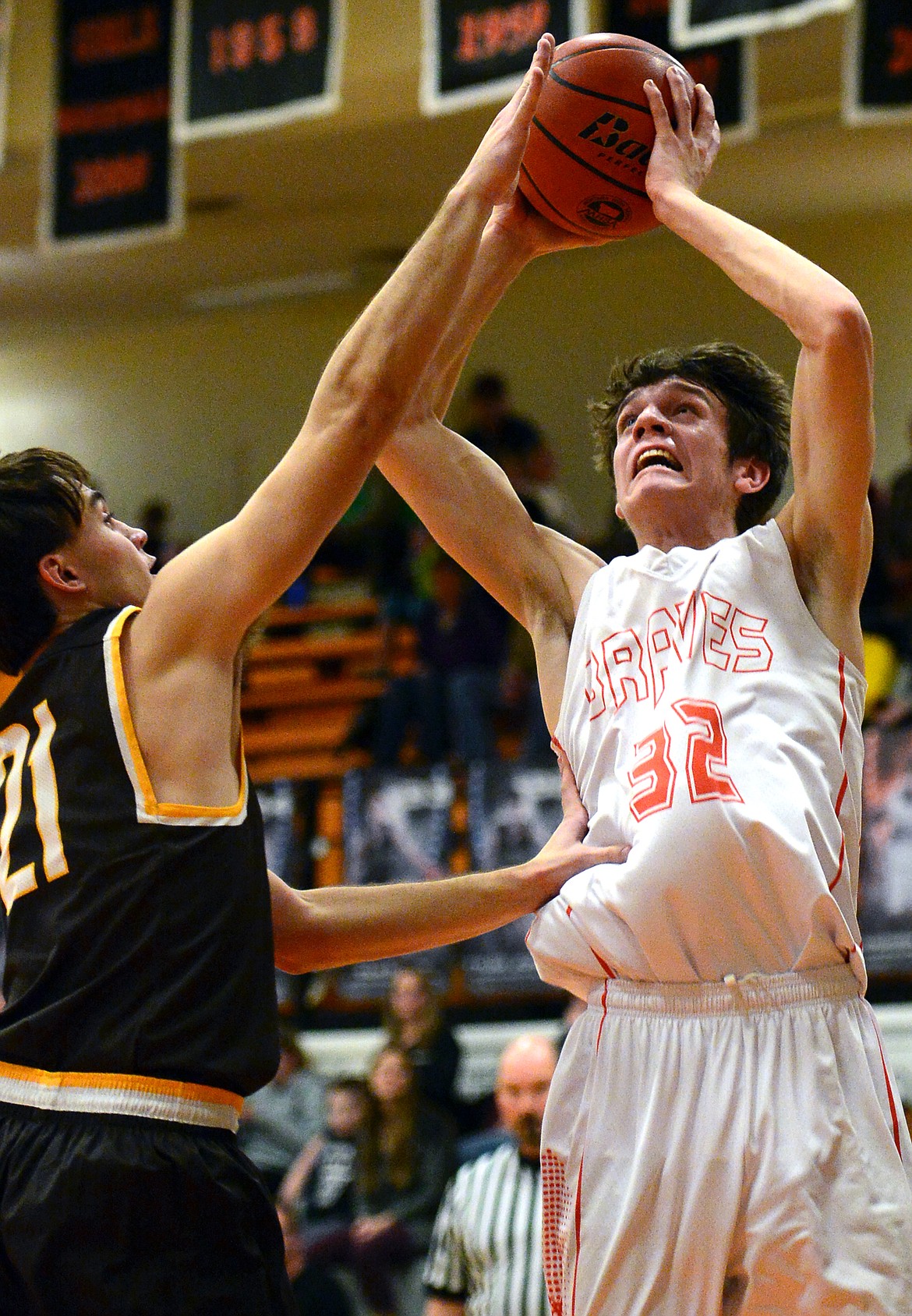 Flathead's Tyler Johnson lays in two points over Helena Capital's Mark Northey on Friday. (Casey Kreider/Daily Inter Lake)