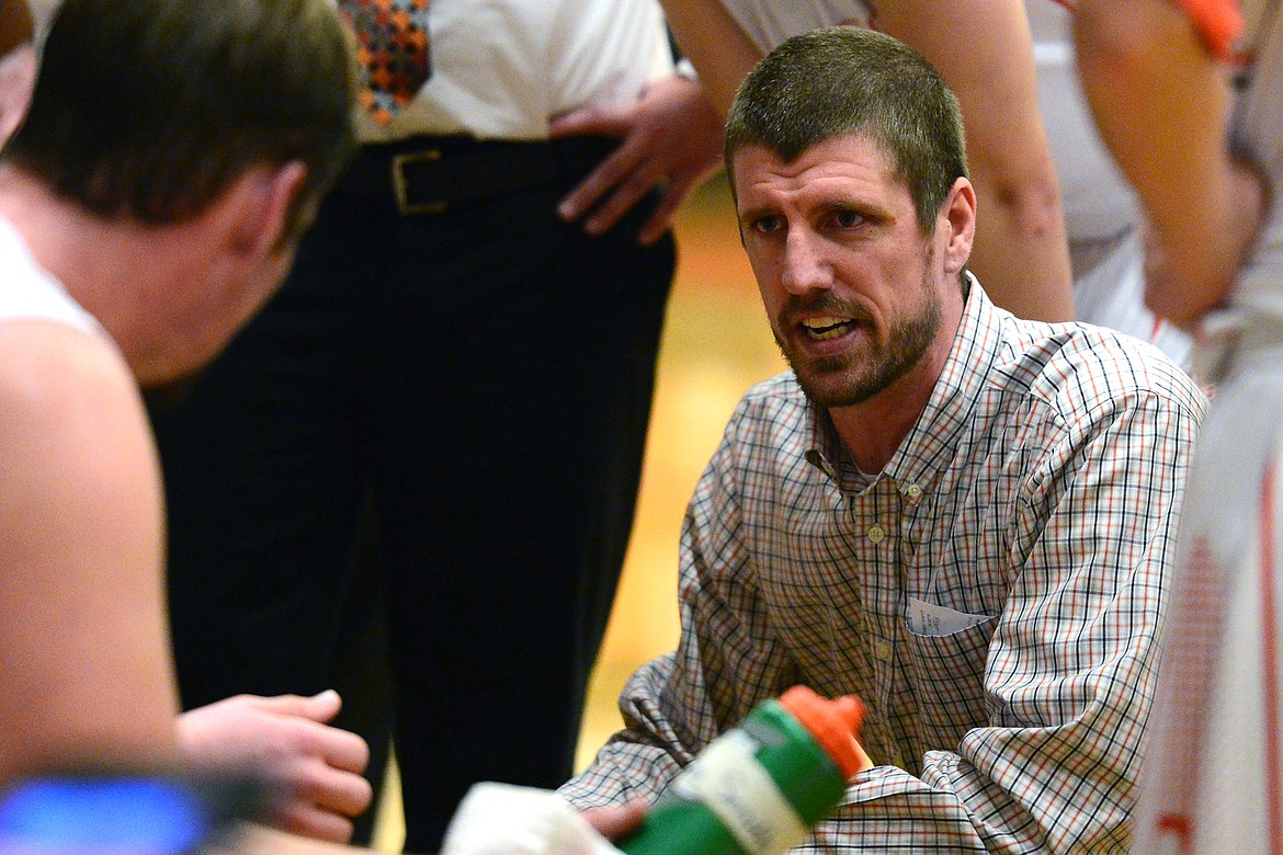 Flathead head coach Ross Gustafson speaks to his team during a timeout in the fourth quarter against Helena Capital at Flathead High School on Friday. (Casey Kreider/Daily Inter Lake)