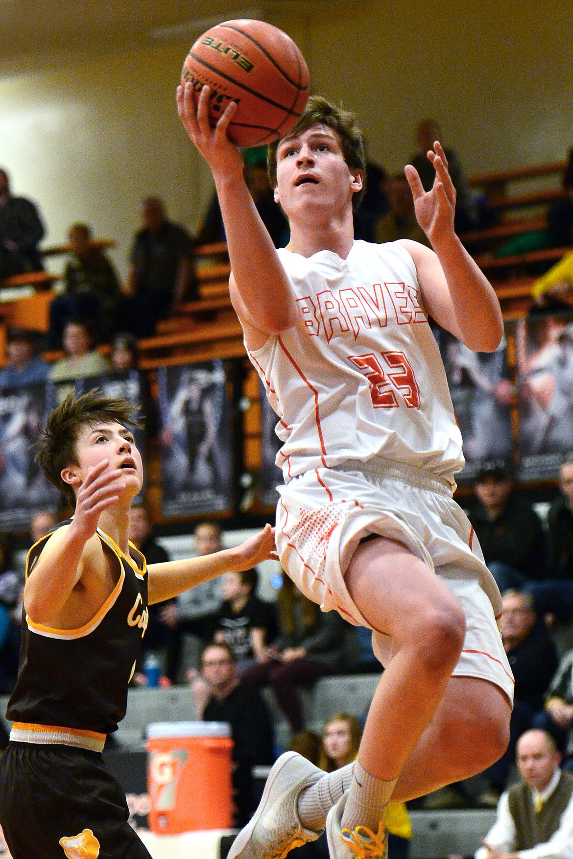 Flathead's Eric Seaman drives to the hoop past Helena Capital's Bridger Grovom on Friday. (Casey Kreider/Daily Inter Lake)