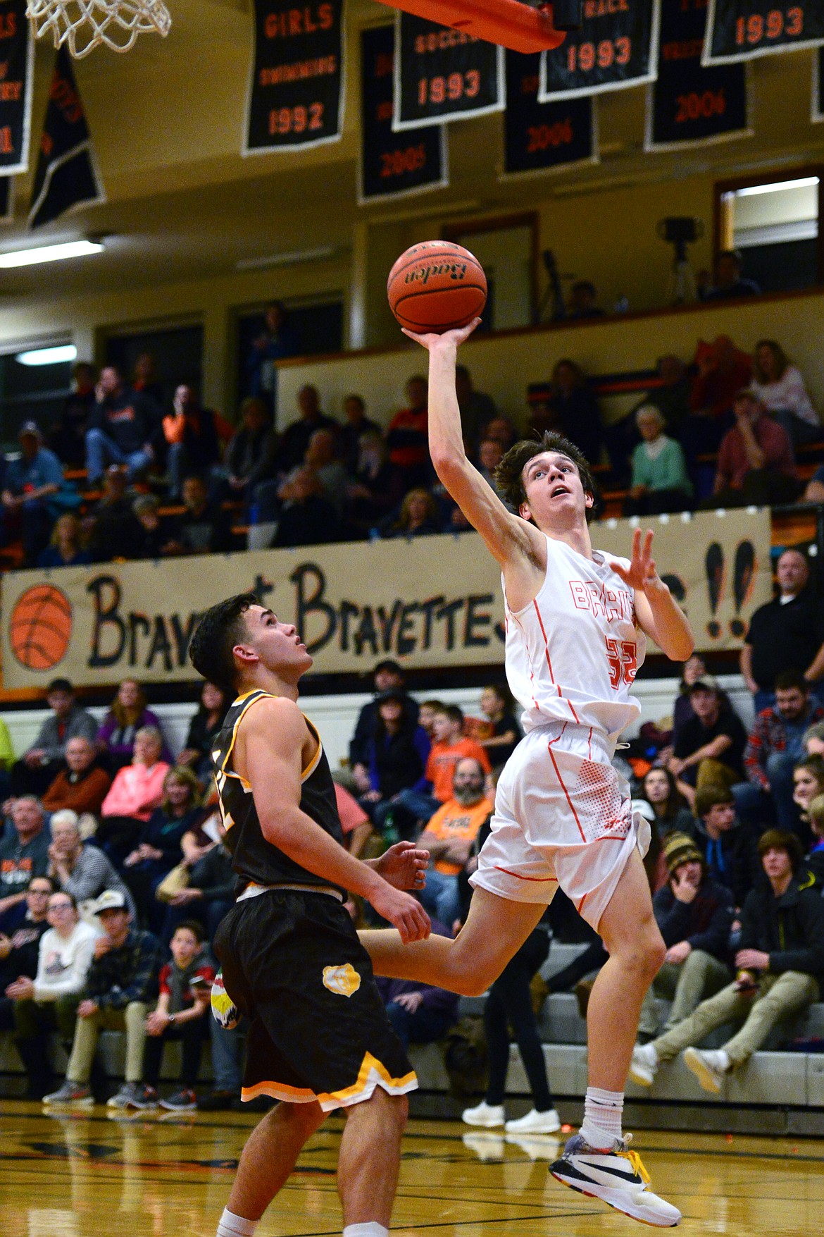 Flathead's Tyler Johnson hits a shot going away from the basket over Helena Capital's Matt McGinley. (Casey Kreider/Daily Inter Lake)