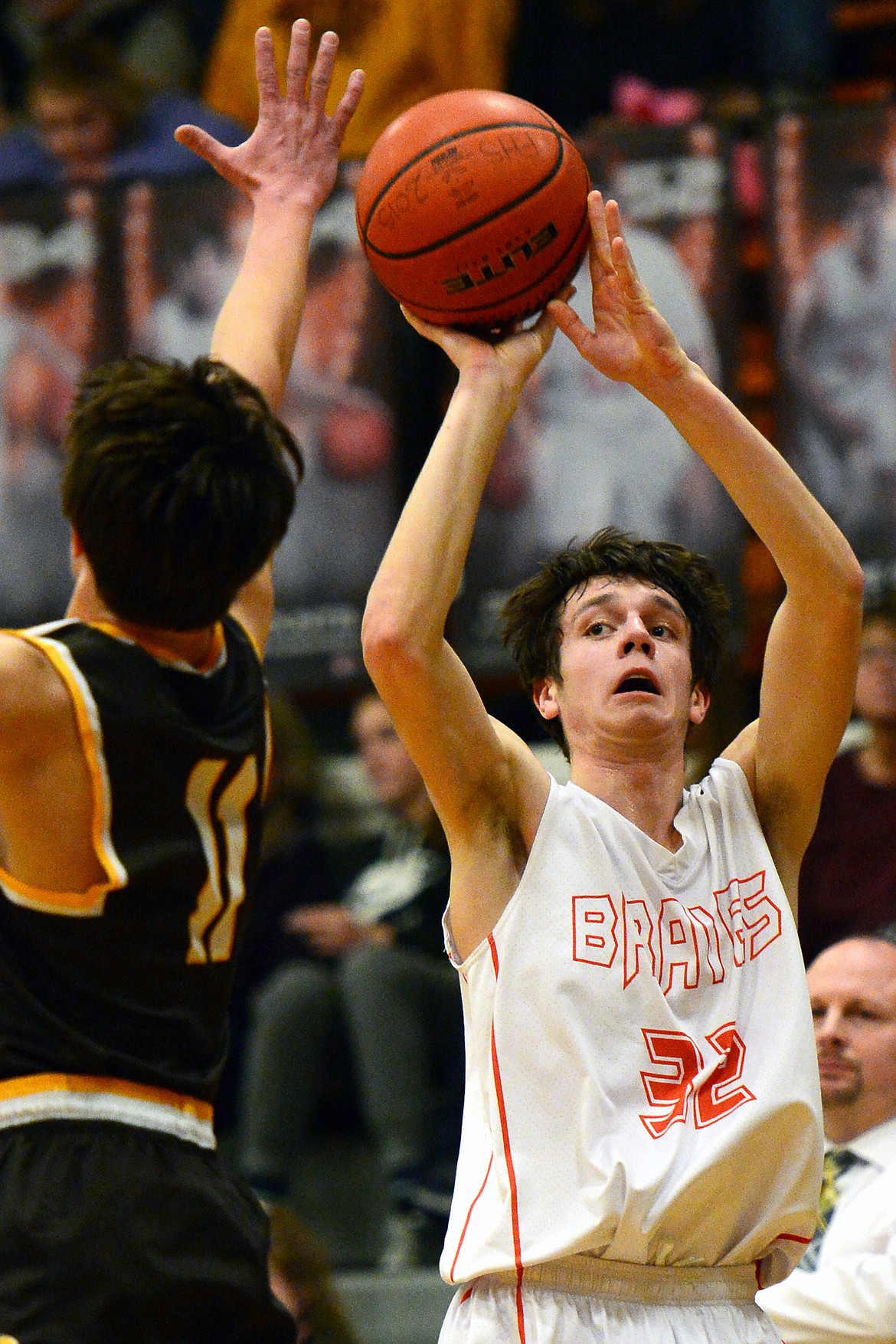 Flathead's Tyler Johnson releases a three-pointer with Helena Capital's Bridger Grovom defending. (Casey Kreider/Daily Inter Lake)