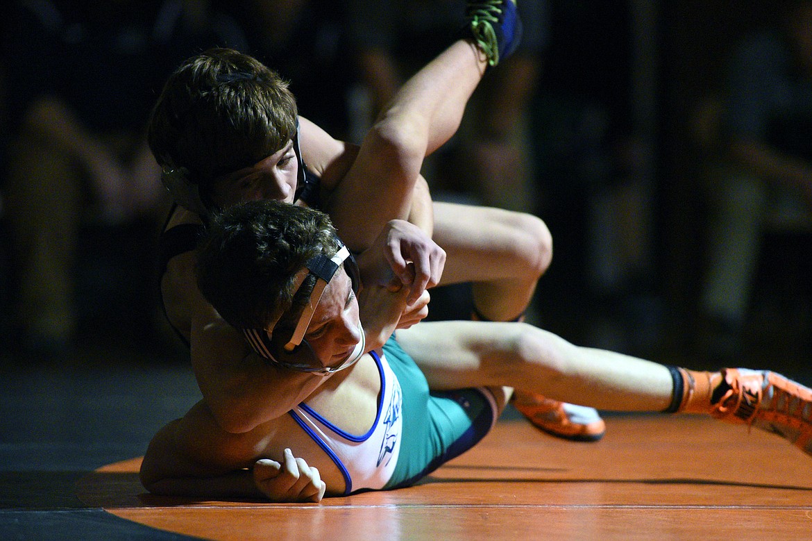 Flathead's Bryce Shaffer works toward a pin of Glacier's Kael Willis at 113 pounds on Thursday at Flathead High School. (Casey Kreider/Daily Inter Lake)