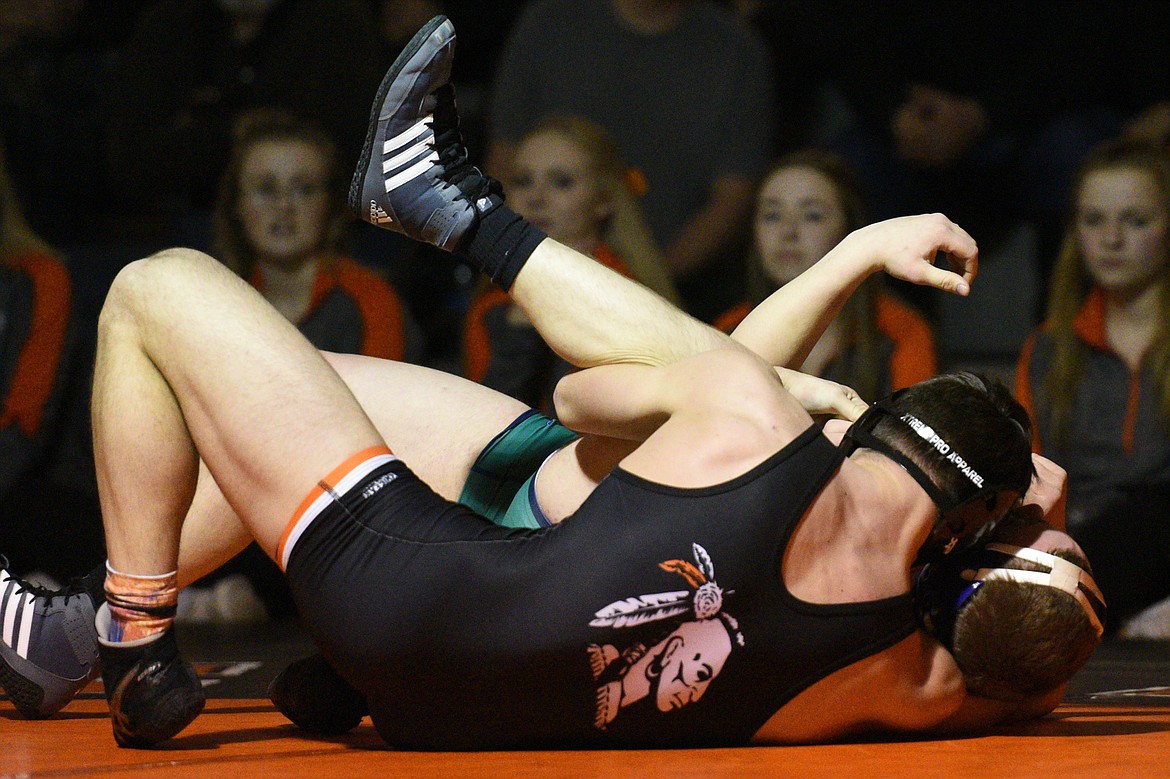 Flathead's Payton Hume works toward a pin of Glacier's Mason Torrez at 170 pounds on Thursday at Flathead High School. (Casey Kreider/Daily Inter Lake)