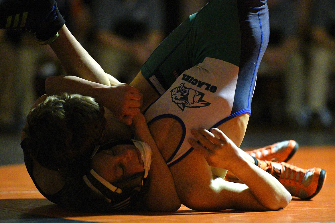 Flathead's Bryce Shaffer works toward a pin of Glacier's Kael Willis at 113 pounds on Thursday at Flathead High School. (Casey Kreider/Daily Inter Lake)