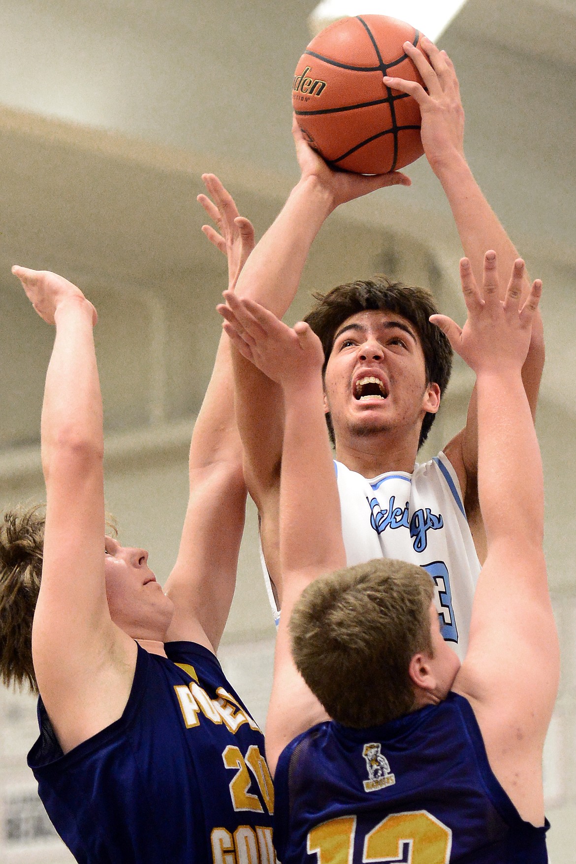 Bigfork's Beau Santisteven looks to shoot with Deer Lodge's Dalton Pauley, left, and Todd Goss defending. (Casey Kreider/Daily Inter Lake)