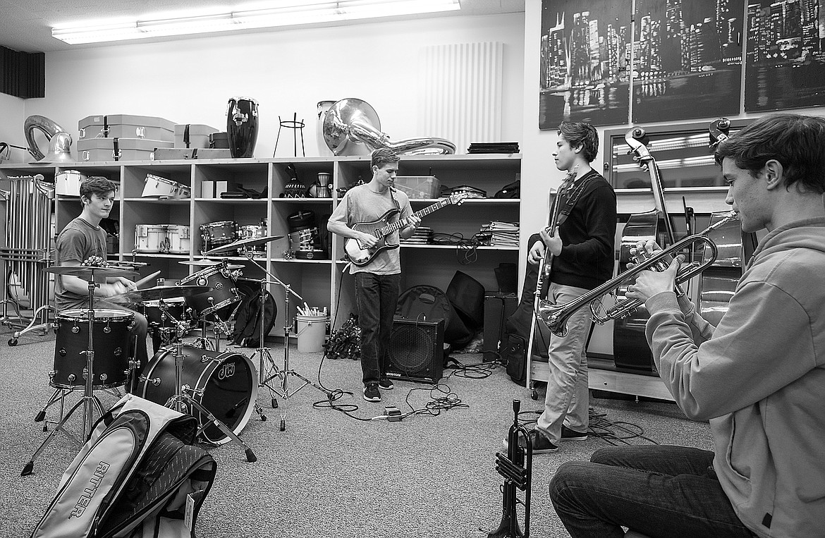 From left, Willie Baltz, Port Nugent, Matthew Perez and Eric Holdhusen practice on Sunday at the Columbia Falls High School band room.