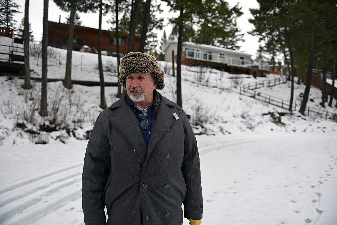 David Guild stands below his residence along the shoreline of Dickey Lake near Trego. (Casey Kreider/Daily Inter Lake)