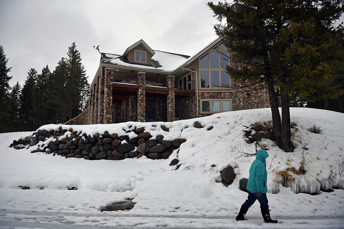 Shawn Sloan walks along the frozen shoreline of Dickey Lake near Trego. (Casey Kreider/Daily Inter Lake)