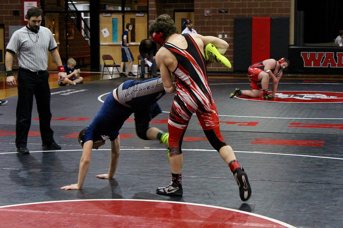 Photo by Chanse Watson/
Carson Hudson prepares to takes his Lake City opponent to the ground during a match at Wallace High School last week.