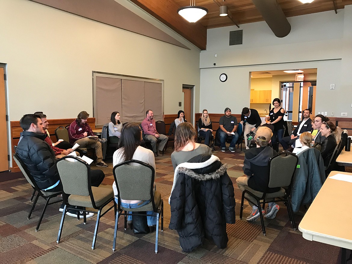 Kootenai County Young Professionals membership director Kelsey Moen, standing, speaks to her peers during a recent Monthly Morning Meeting in the Kroc Center. These meetings are held the first Tuesday of every month at 7 a.m. to help start the month off right with networking, getting involved with charities needing volunteers and hearing about what KCYP is doing that month and the following months. (Photo by TRENT GRANDSTAFF/KCYP)