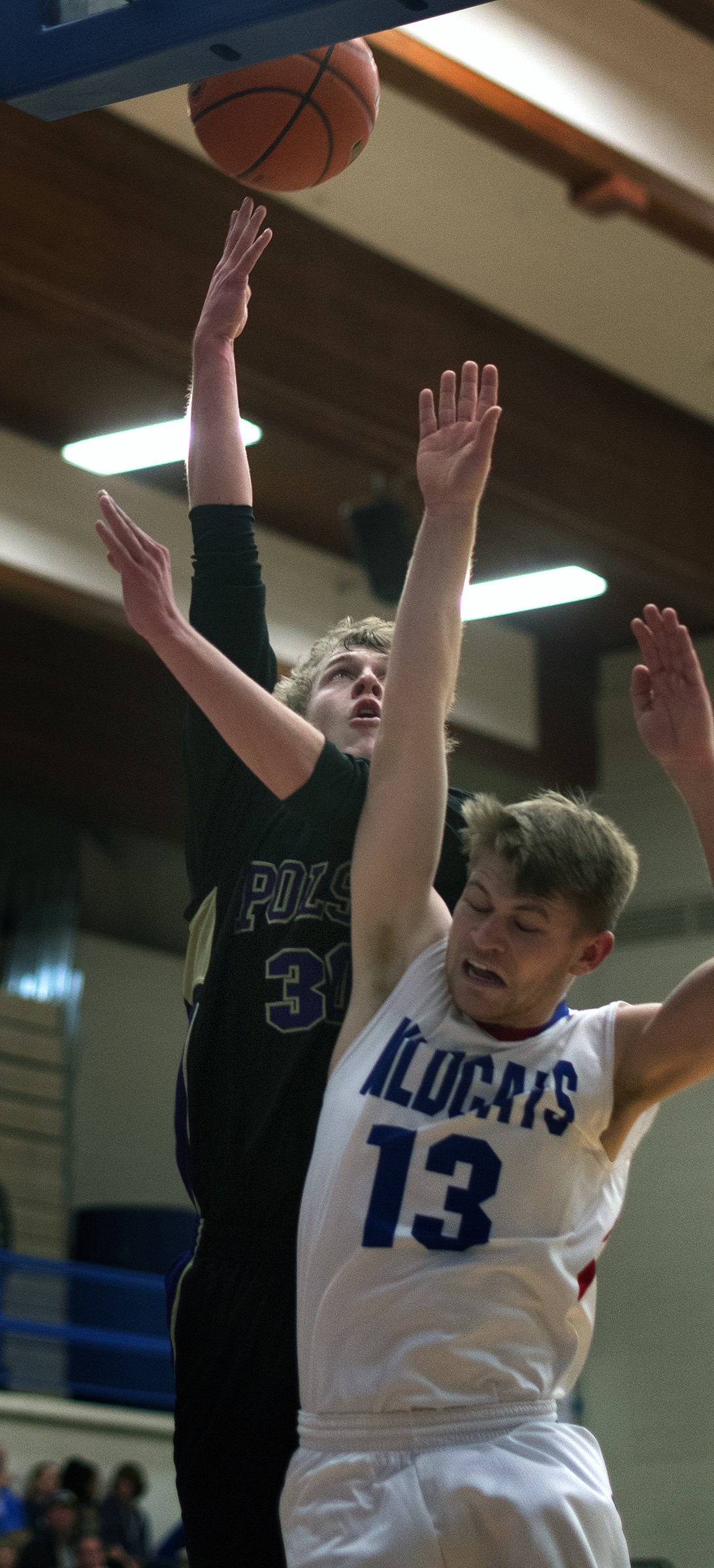 Polson guard Connor Lanier takes a shot over Columbia Falls guard L.J. Panasuk. Lanier led the Pirates with 20 points as Polson won the game, 56-48. (Jeremy Weber photo)