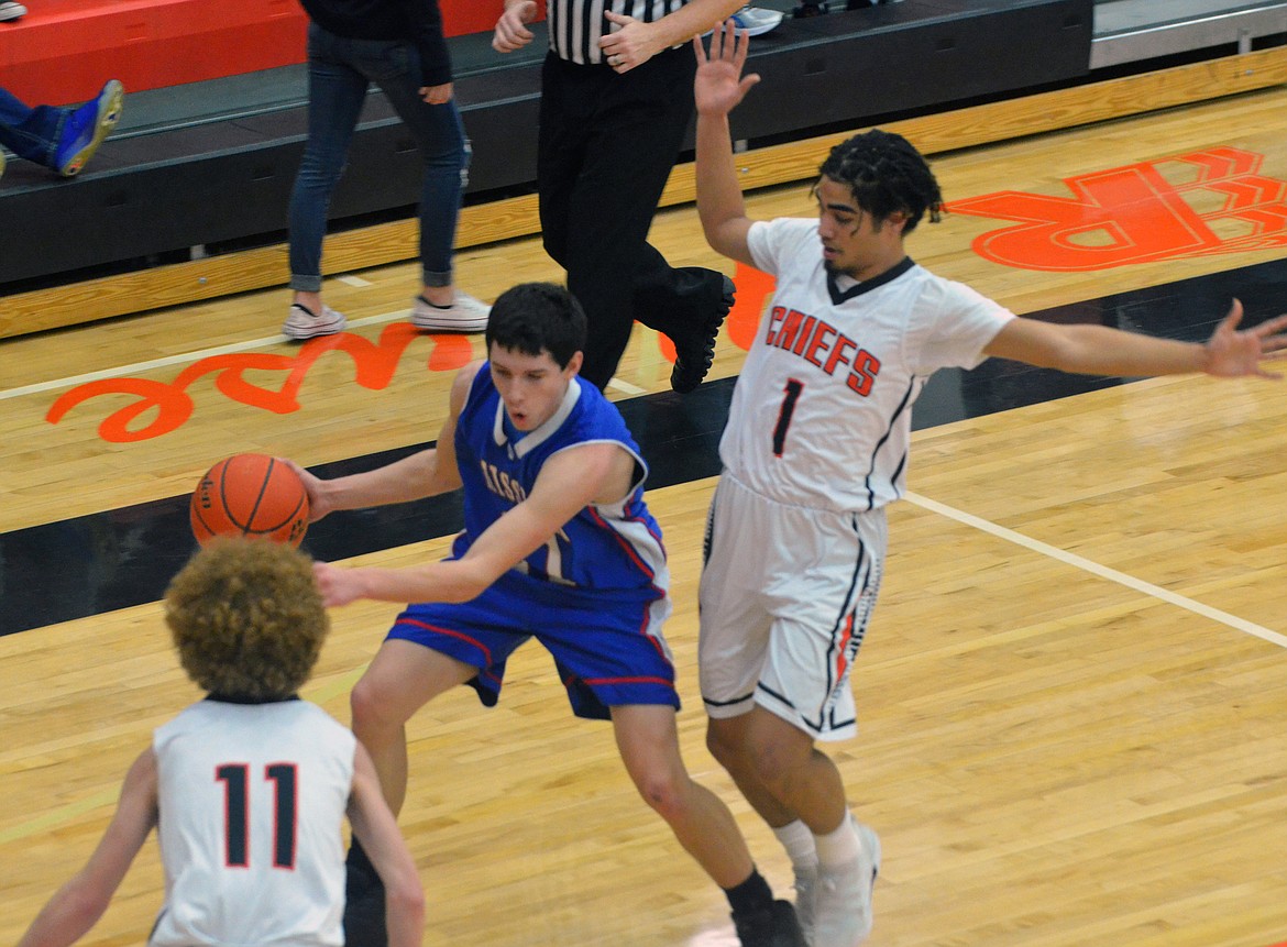 RONAN HIGH School guard Ezekiel Misa (1) and Nate Dennis (11) attempst to trap Mission guard Wacey McClure (21) in Ronan's 66-61 victory over Mission High School Saturday afternoon at the Ronan Events Center. (Jason Blasco/Lake County Leader)