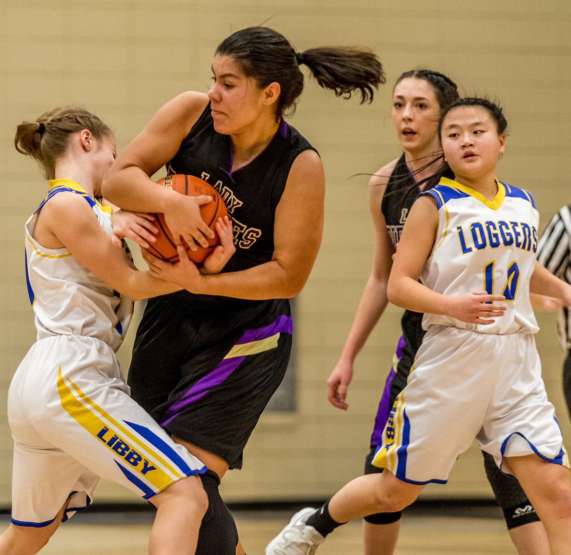 Libby&#146;s Linsey Walker and Polson&#146;s Olivia Perez fight for control of the ball as Polson&#146;s Kaelyn Smith and Libby&#146;s Syd Gier await the outcome Saturday.