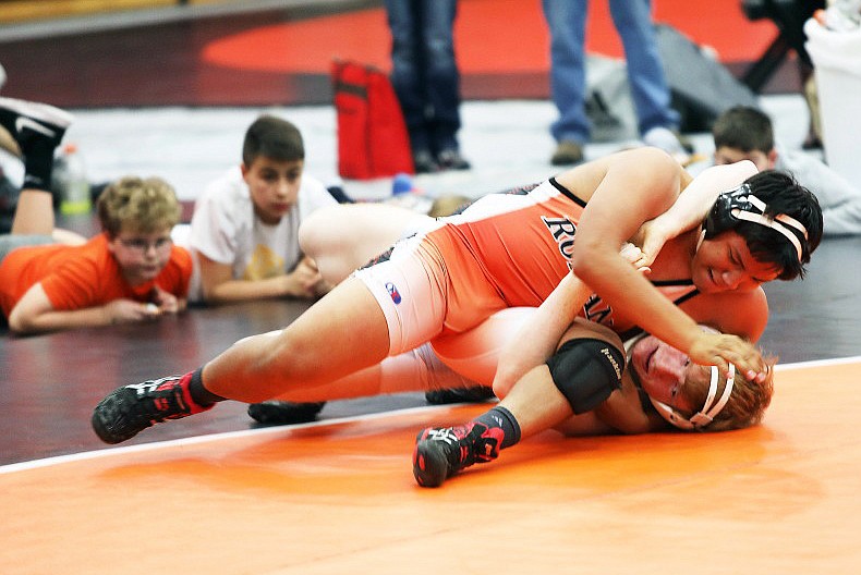 RONAN WRESTLER Jesse Littleboy attempts to pin a Mission-Charlo wrestler during the Western Montana Duals at the Ronan Events Center. The Chiefs' wrestling program is getting ready to prepare for the most intense portion of their season. (photo by Susan Lake/Special to the Lake County Leader)