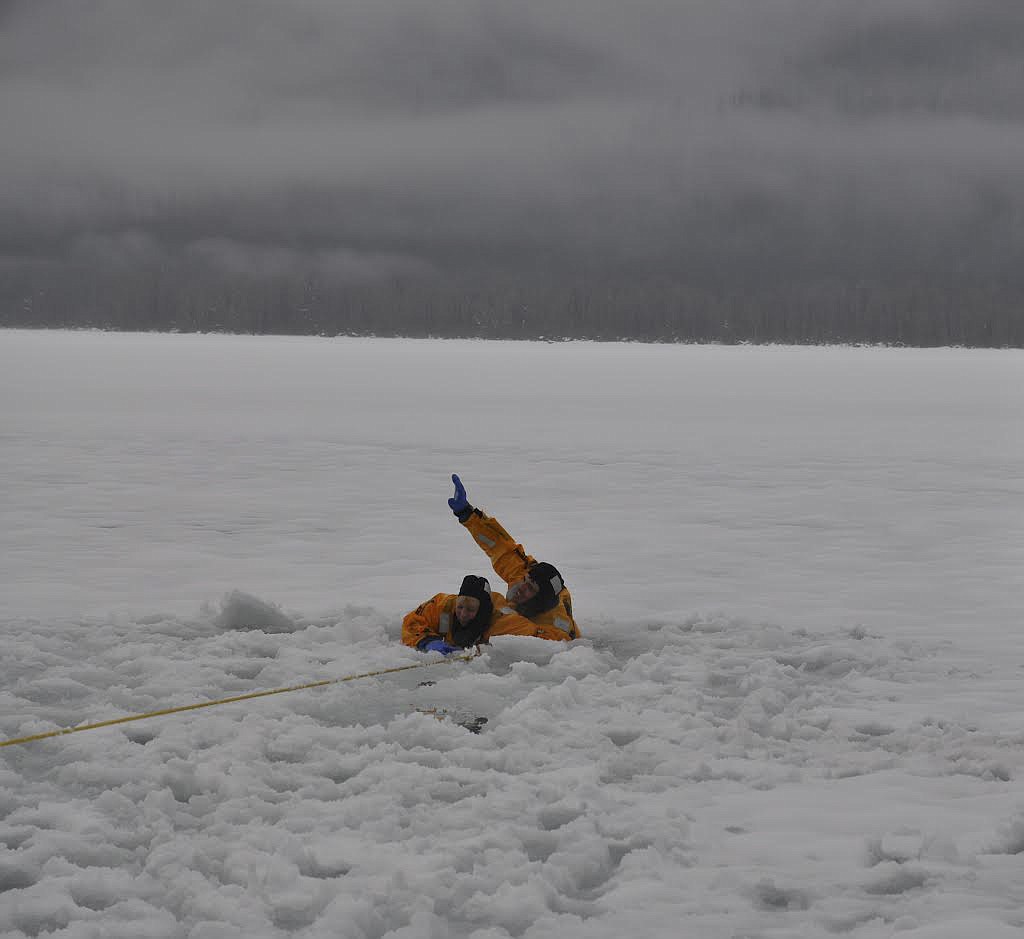 Carol Fields, left, and Ryan Gembala, both members of the Swan Mission Search and Rescue, participate in training Sunday morning at Swan Lake.