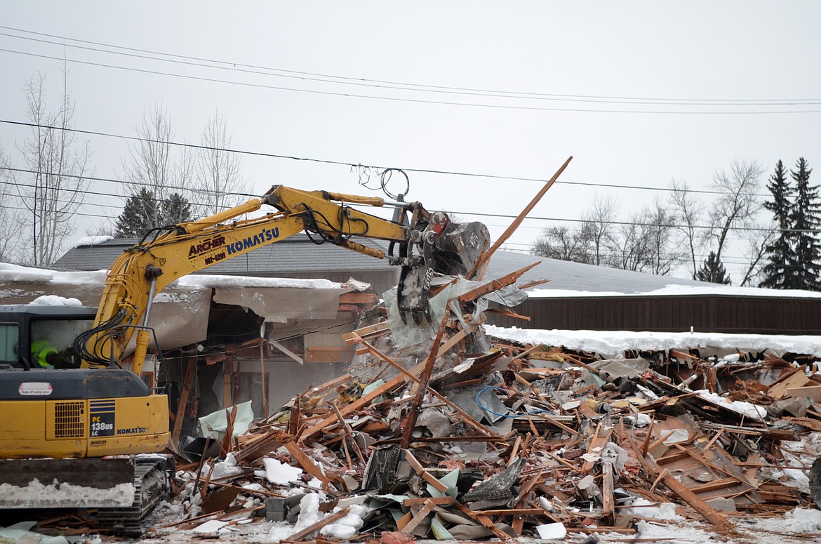 An excavator demolishes the Frank Lloyd Wright Building on Central Avenue Thursday morning. (Heidi Desch/Whitefish Pilot)