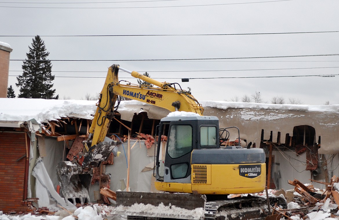 An excavator demolishes Frank Lloyd Wright Building Thursday morning. (Heidi Desch/Whitefish Pilot)