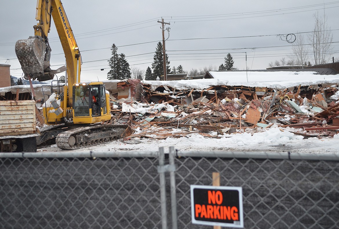 Crews continued to demolish the Frank Lloyd Wright Building Thursday morning. Excavators loaded debris into dump trucks. (Heidi Desch/Whitefish Pilot)