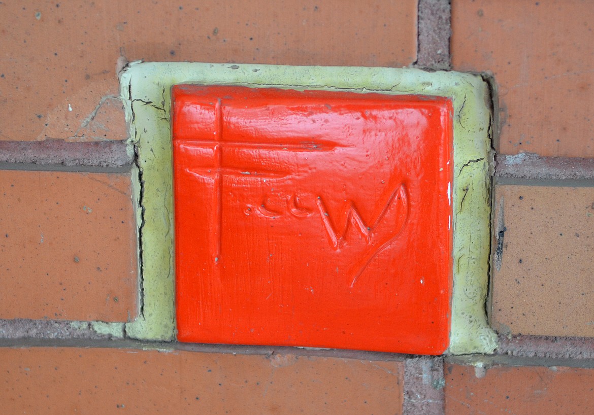 A red tile incorporated into the brickwork bears the signature of Frank Lloyd Wright. (Heidi Desch/Whitefish Pilot)